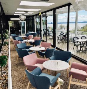 a row of tables and chairs in a restaurant at Vättersmålen Stuga in Gränna