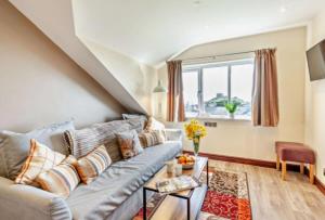 a living room with a couch and a window at Lion Hotel & Studio Apartments in Criccieth