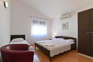 Postel nebo postele na pokoji v ubytování Apartments Andrea I