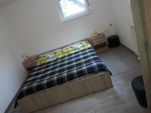a bed sitting in a room with a window at Apartments Rozi in Bovec