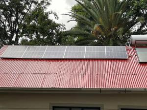 a group of solar panels on the roof of a house at Ultra modern 2 bedroomed apartment - 2082 in Bulawayo