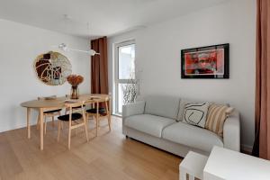 a living room with a couch and a table at Boutique Aura 40 by Grand Apartments in Gdańsk