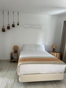 a bedroom with a large bed with white sheets at À Espera - Turismo Rural,Melides in Melides