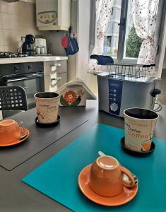 a kitchen with two cups and plates on a counter at La Nchioscia in La Spezia