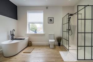 a bathroom with a bath tub and a toilet at 3 bed house sleeps 6 walking distance in to Nottingham city centre ideal for contractors and corporate travellers in Nottingham