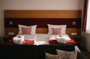 a bedroom with two beds with towels on them at Berghotel Wiedener Eck in Wieden