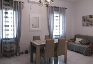 a dining room with a table and chairs and a bed at Vion Place Pilos in Pylos
