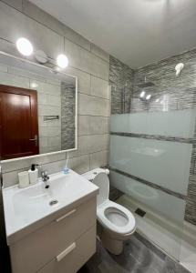 a bathroom with a toilet and a sink and a shower at Casa Uma in Corralejo