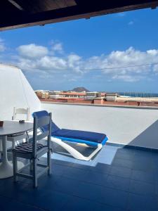 a chair and a table on top of a roof at Casa Uma in Corralejo