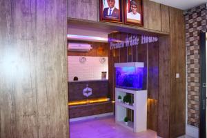 a room with a fish tank on a wall at PRESKEN WHITE HOUSE in Lagos