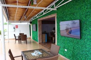 a room with a green wall with a table and chairs at PRESKEN WHITE HOUSE in Lagos