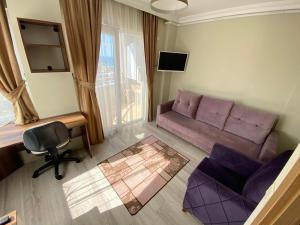 トラブゾンにあるBorahan Apartの紫色のソファと椅子が備わるリビングルーム