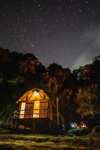 a wooden cabin under a starry sky at night at Montanha Home in Monte Verde