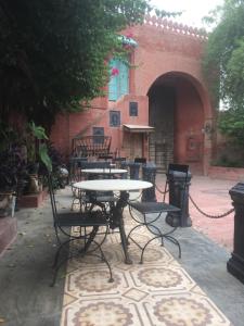 a patio with tables and chairs in a courtyard at Bhairon villas in Bikaner