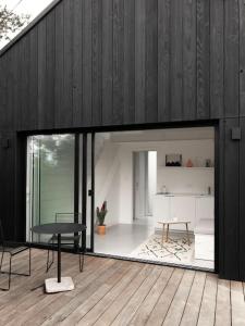 a living room with a table and a desk at Tiny House d'exception au bord de mer in La Bernerie-en-Retz