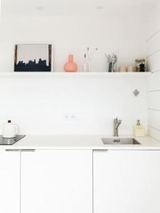 a kitchen with white cabinets and a sink at Tiny House d'exception au bord de mer in La Bernerie-en-Retz