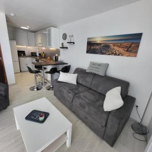 a living room with a couch and a table at L èphéjules in Marseillan