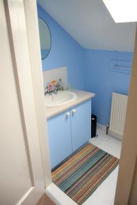 a bathroom with a sink and a mirror at The Stables in Carsethorn +30 photos