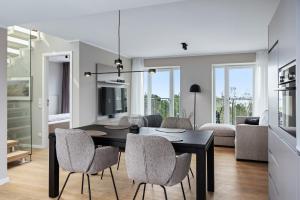 a dining room and living room with a table and chairs at Strandresidenzen Binz-Prora Strandresidenzen Binz-Prora D5 5 in Binz