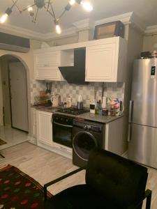 a kitchen with a stove and a refrigerator at Ardor’s apartment in Antalya