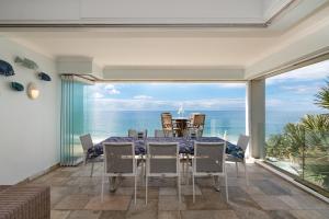 a dining room with a view of the ocean at The Islands 13 - Newly renovated with UPS that powers TV, Wifi and 1 light in Ballito