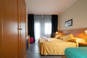Postel nebo postele na pokoji v ubytování Hotel Sabbie d'Oro