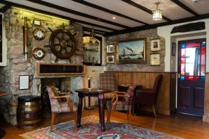 a dining room with a table and a stone wall at The Olde Ship Inn in Seahouses