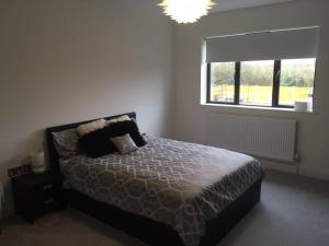 a bedroom with a bed and a large window at Luxury detached house - Village 