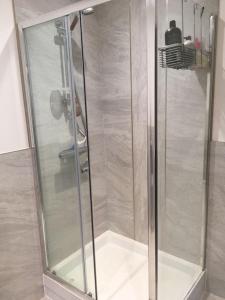 a shower with a glass door in a bathroom at Luxury detached house - Village 