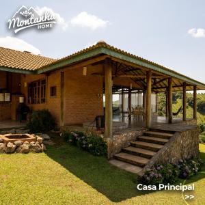 a house with a wooden gazebo in a yard at Casa Principal Montanha Home in Monte Verde