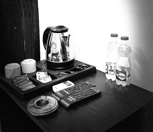 a coffee maker and remote controls on a table at Hotel Ace Plaza in Udaipur