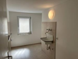 a bathroom with a sink and a window at TTP 15 Markdorf in Markdorf