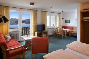 a hotel room with a view of a living room at Landhaus Seeblick in Füssen