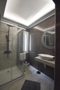 a bathroom with a toilet and a sink and a shower at K&C Rooms- Apartments in Markopoulo