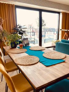 a wooden table with four straw hats on top at Cozy two bedroom Apartment near city centre Gent in Ghent