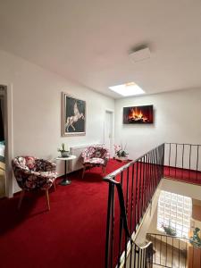 a living room with two chairs and a fireplace at Apartment Mia in Neusiedl am See