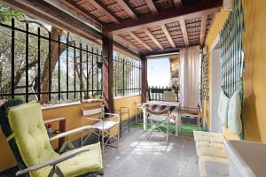 a balcony with chairs and a table and windows at Alloggio di Charme in Bonassola