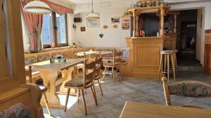 - un restaurant avec des tables et des chaises dans une salle dans l'établissement Waldpension Am Köpfchen, à Kurort Steinbach-Hallenberg