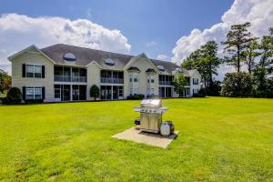 a large house with a grill in the yard at Scotch Broom I-102 in Little River