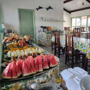 a buffet of fruit on display in a restaurant at Hotel Porto Verde -JG in Porto Seguro