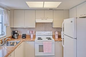 a kitchen with white appliances and a white refrigerator at Good Vibes - Serenity in Naples