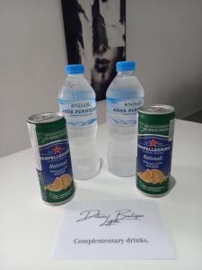 three bottles of water sitting on top of a paper at Deluxe boutique lodge in Vara Blanca