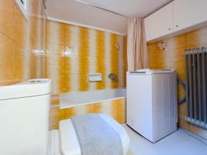 a bathroom with a toilet and a small refrigerator at Kairi Cozy 92sqm apt in Nea Smirni in Athens
