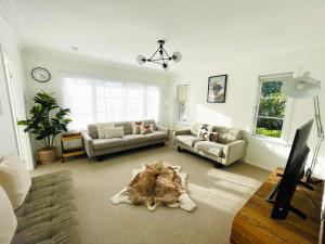 a living room with a couch and a table at Alta House in Auckland