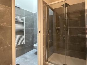 a bathroom with a shower with a glass door at Royal Garden luxury rooms in Padova