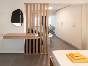 a kitchen with white cabinets and a table at Zen Central Luxury Apartment in Heraklio
