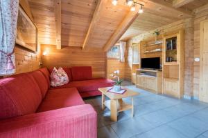 a living room with a red couch and a table at Ferienhaus Pichlerhof in Fundres