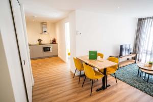 a dining room and kitchen with a table and chairs at Happy 1 Bedroom Apartment - WE39C in Tiel