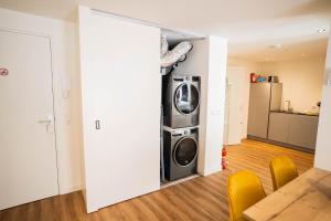 a living room with a washer and dryer in a house at Happy 1 Bedroom Apartment - WE39C in Tiel