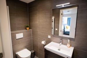 a bathroom with a sink and a toilet and a mirror at Happy 1 Bedroom Apartment - WE39C in Tiel +52 photos